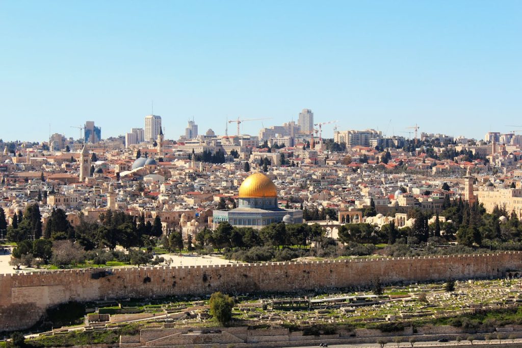Stunning aerial shot of the Dome of the Rock and Jerusalem skyline, capturing the historic and urban landscape.